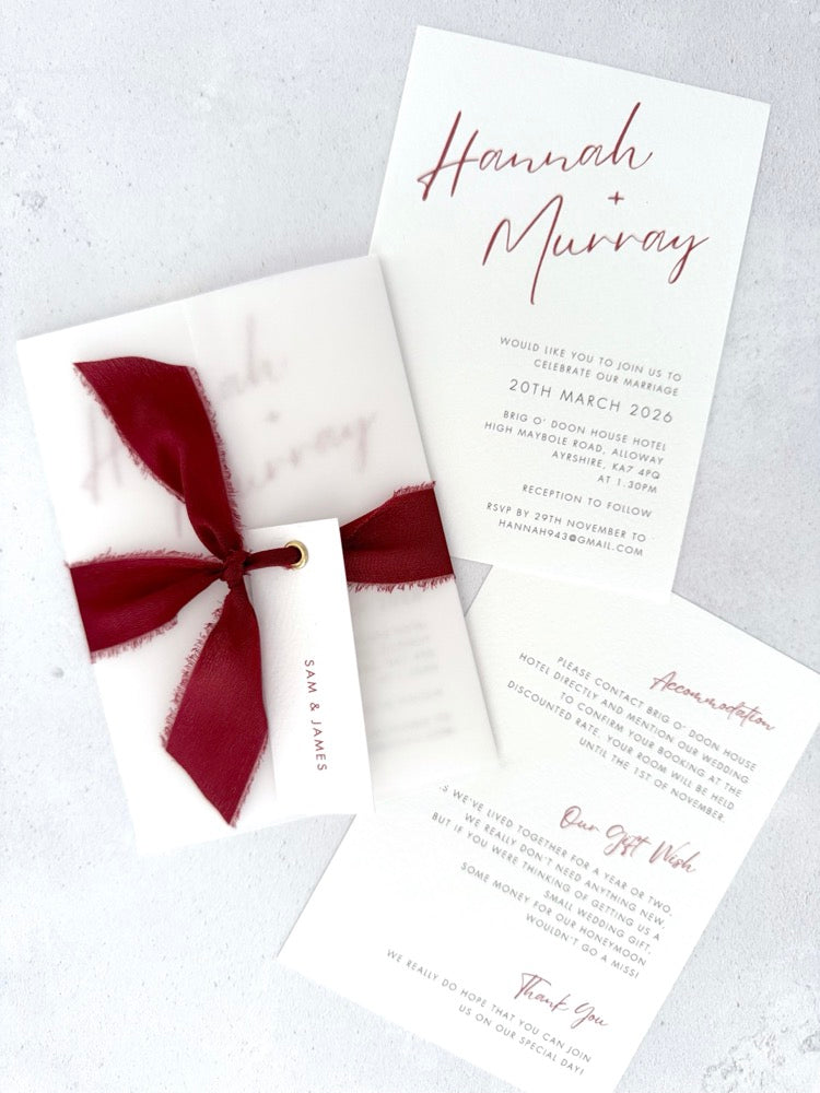 Burgundy Hannah vellum wrap wedding invite with tied silk ribbon and guest name tag. Insert card for wedding info and menu options.