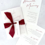 Burgundy Hannah vellum wrap wedding invite with tied silk ribbon and guest name tag. Insert card for wedding info and menu options.