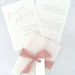 Blush Pink Hannah wedding invitation with tied silk ribbon and transparent vellum jacket. Guest name tag with metal eyelet.  Insert card for wedding info and menu options.