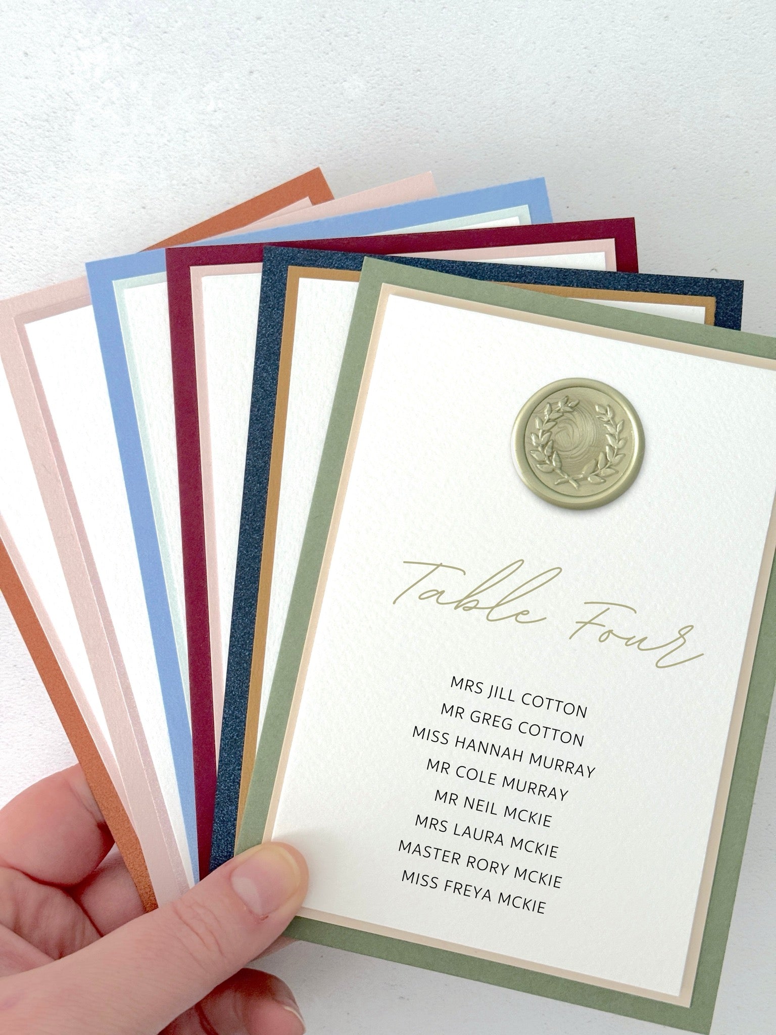 Sage green wax seal Jeni individual table plan card on the day wedding stationery