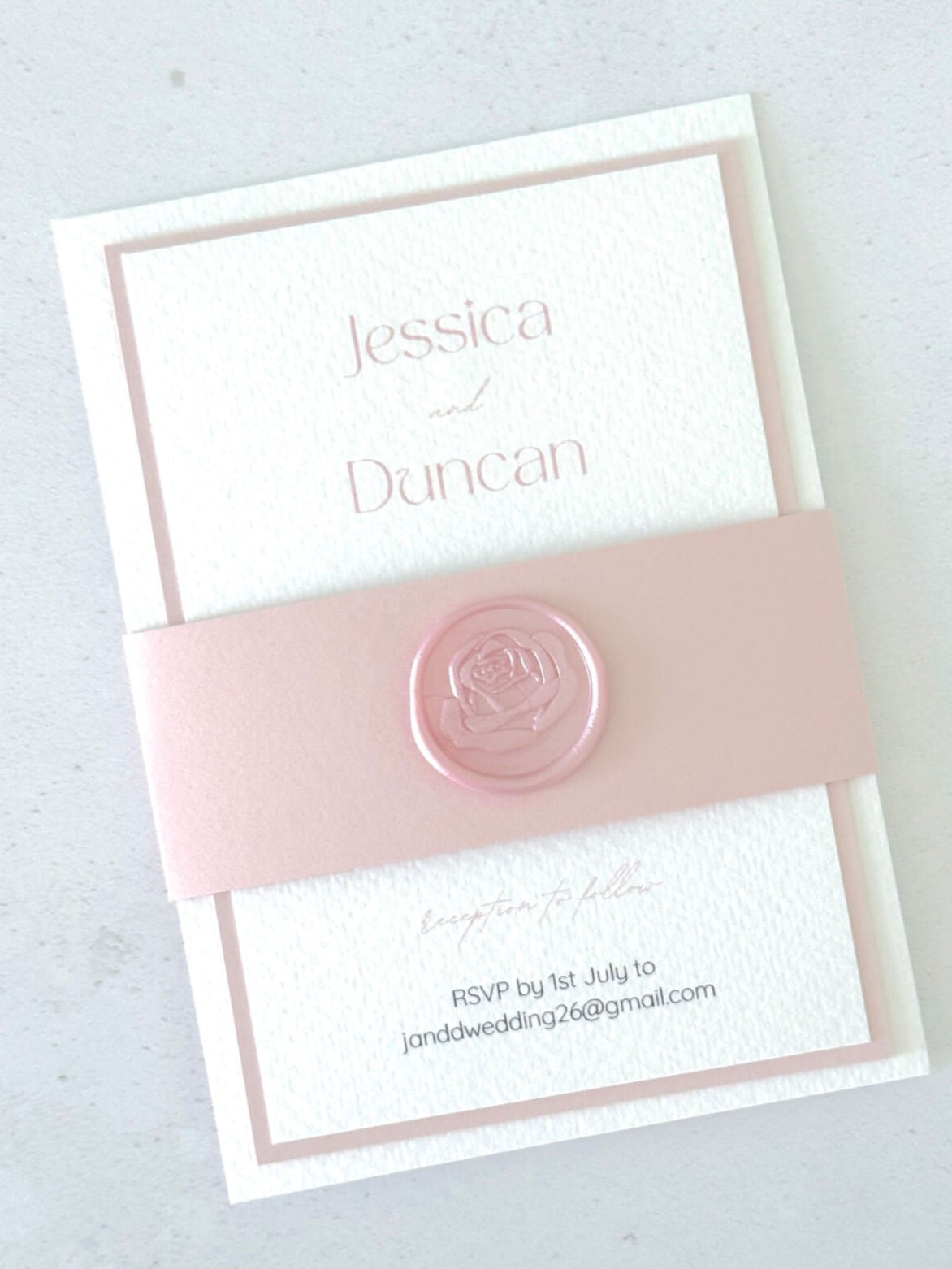 pink belly band and rose wax seal wedding invite