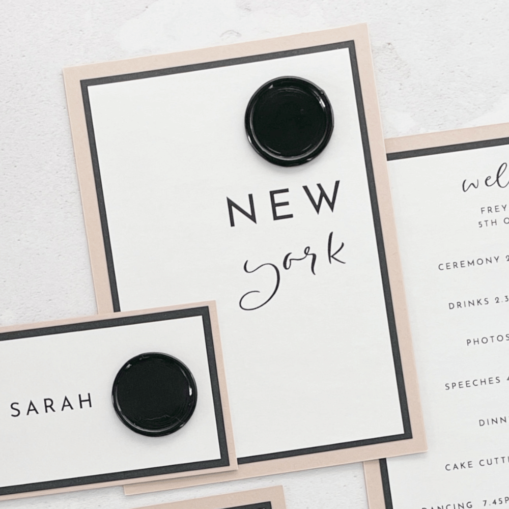 Minimalist nude and black wax seal on the day wedding stationery