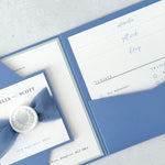 Dusty blue pocket wedding invite with info and gift wish cards