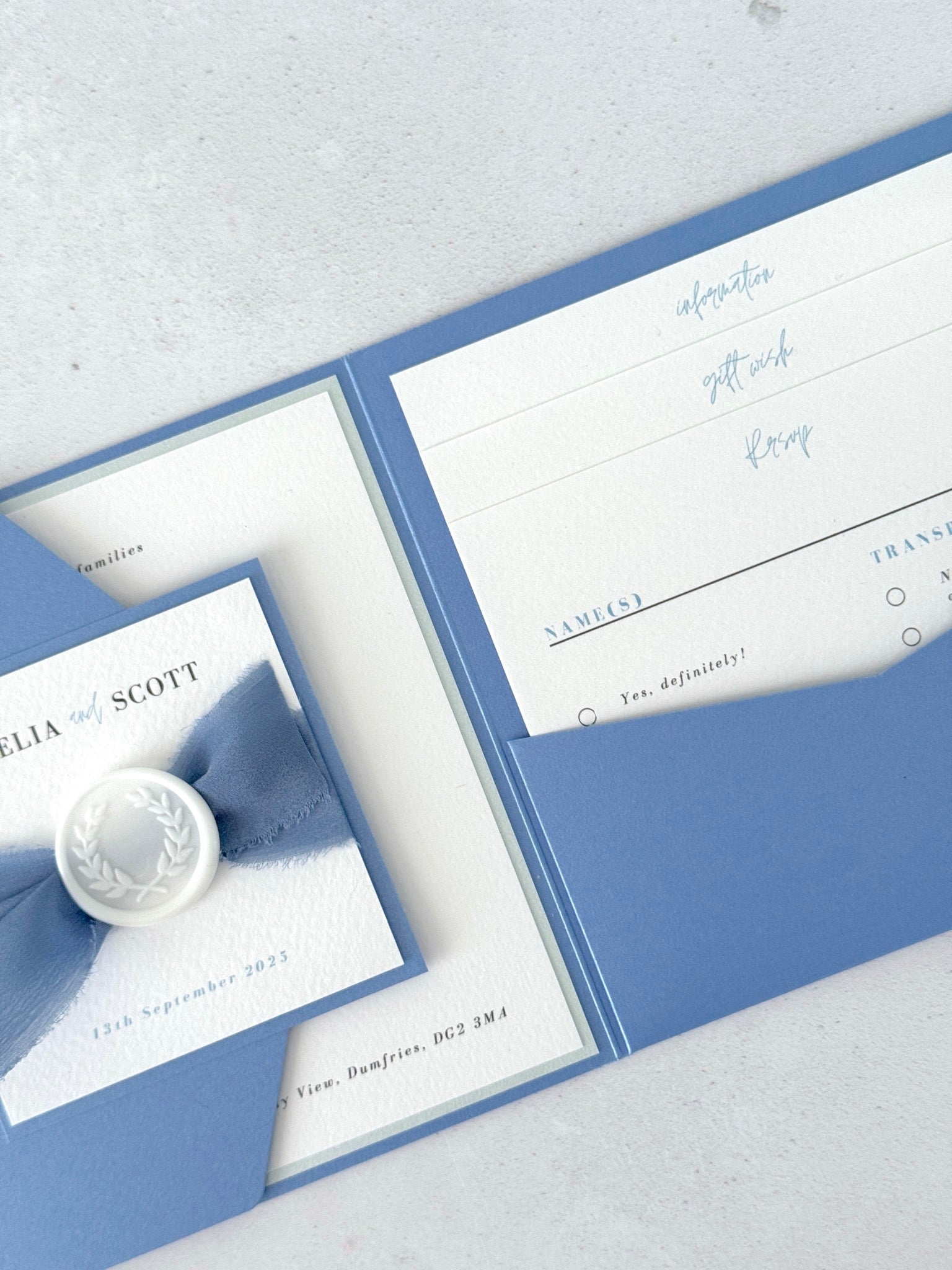 Dusty blue pocket wedding invite with info and gift wish cards