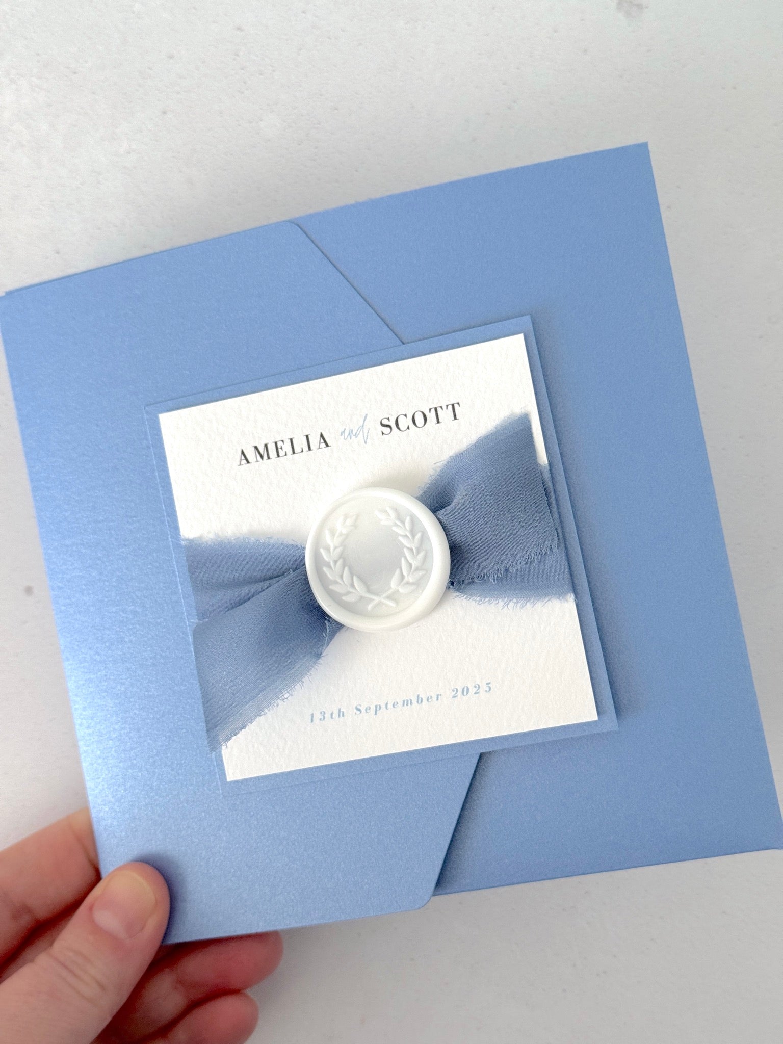 Dusky Blue pocket wedding invite with silk ribbon and handmade wax seal