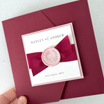 Burgundy red Ailsa pocket wedding invitation with satin ribbon and pink wax seal