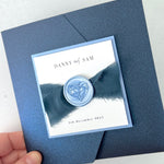 Pearlescent navy and dusty blue pocket wedding invite with silk ribbon and wax seal