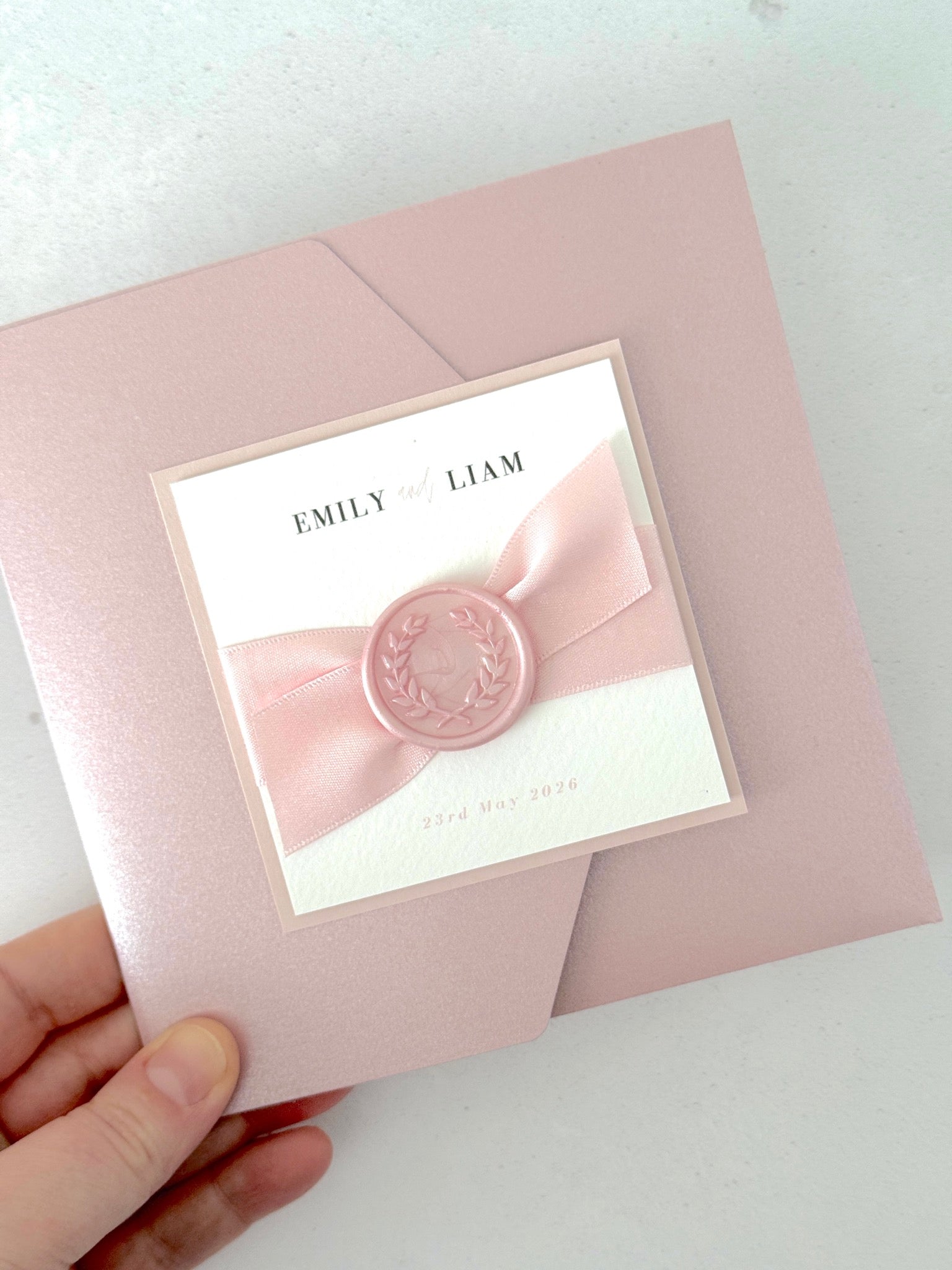 Misty rose pink square pocketfold wedding invite with pink satin ribbon and handmade wax seal