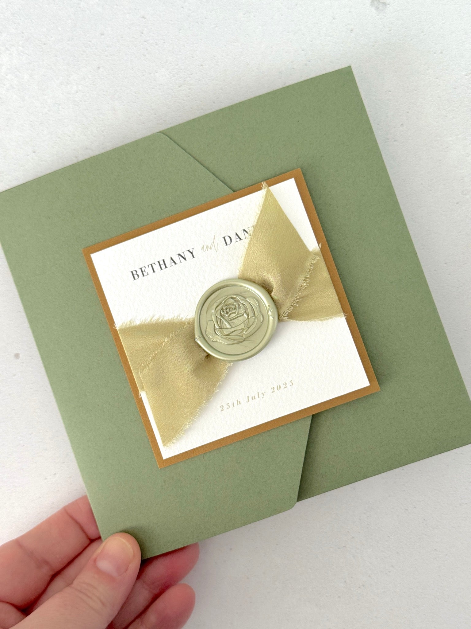 Handmade sage green ailsa wedding invite with silk ribbon and wax seal