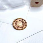 gold wax seal with olive leaf wreath