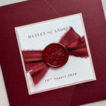 Pocket wedding invite with info cards in burgundy with silk ribbon and foliage design wax seal