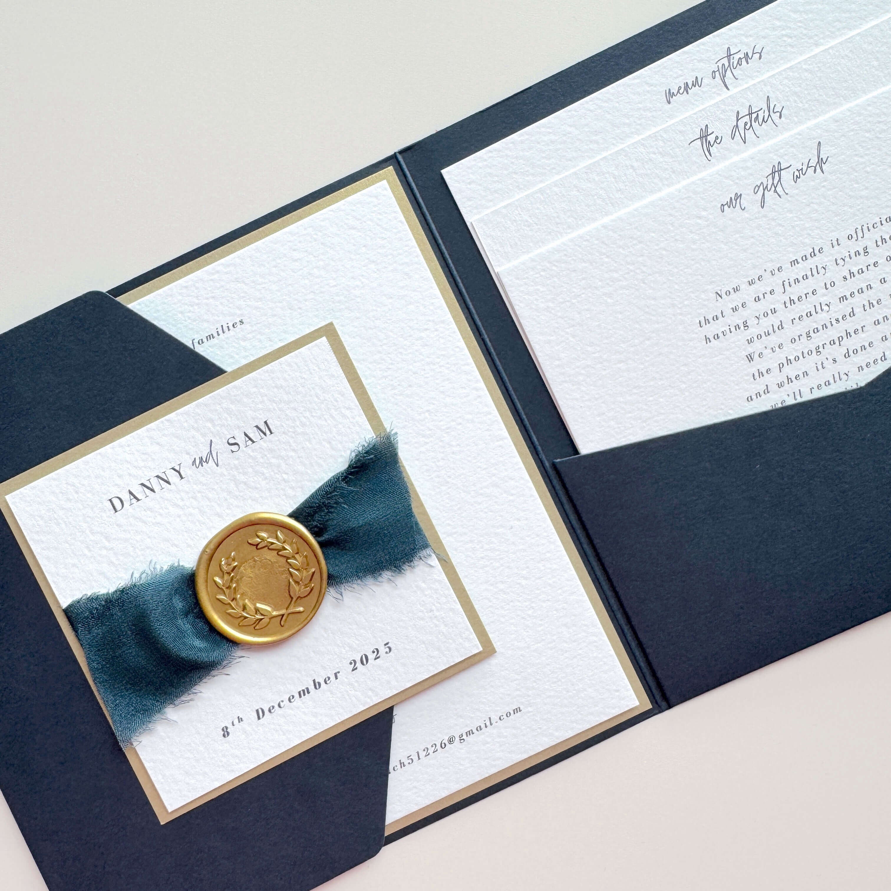 Navy pocketfold invite with gold wreath wax seal and navy silk ribbon with 3 inserts for wedding menu options and info