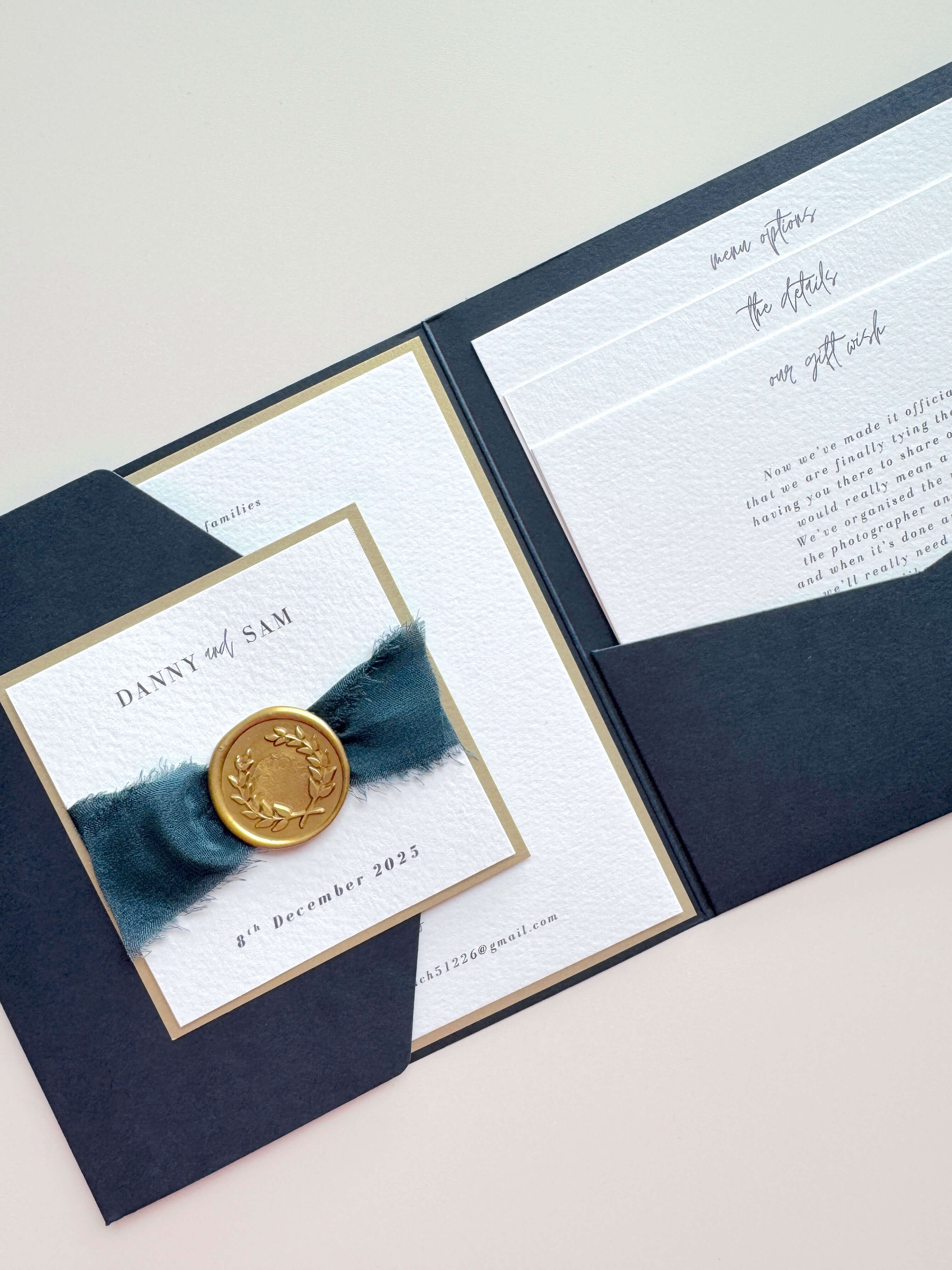 Navy pocketfold invite with gold wreath wax seal and navy silk ribbon with 3 inserts for wedding menu options and info