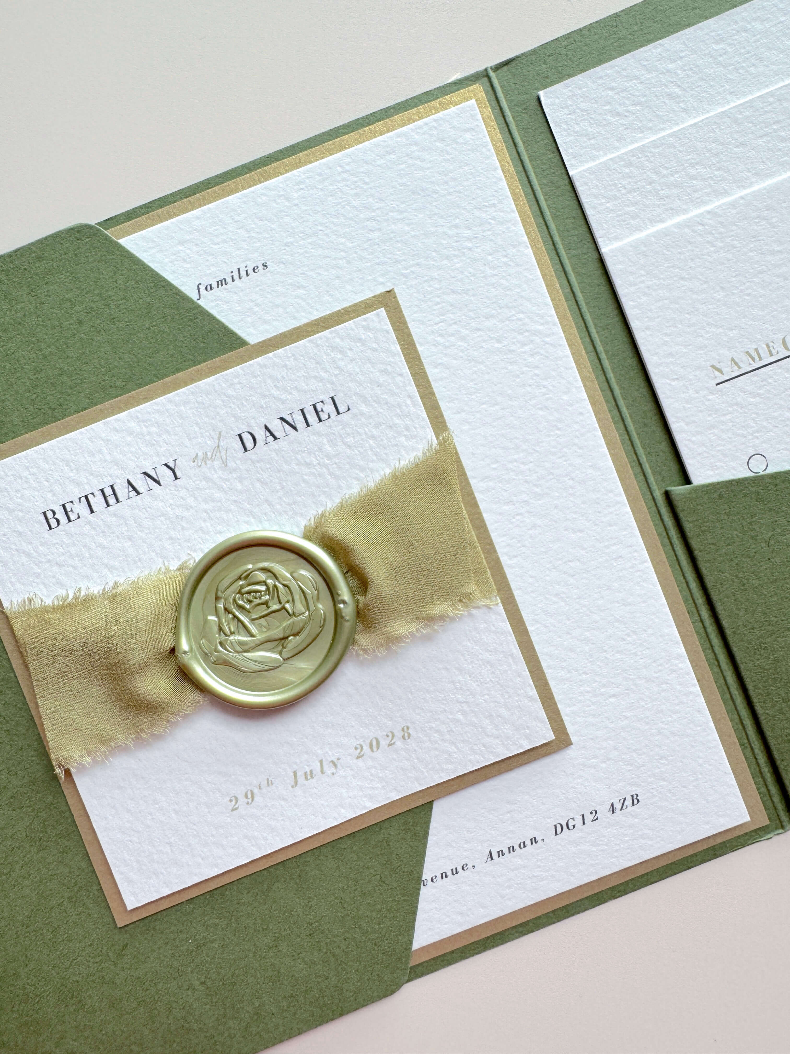 Handmade sage green ailsa wedding invite with silk ribbon and wax seal