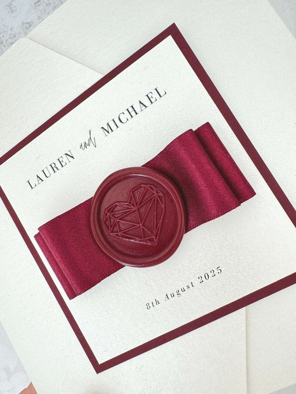 Ailsa burgundy wax seal and satin bow pocketfold wedding invite