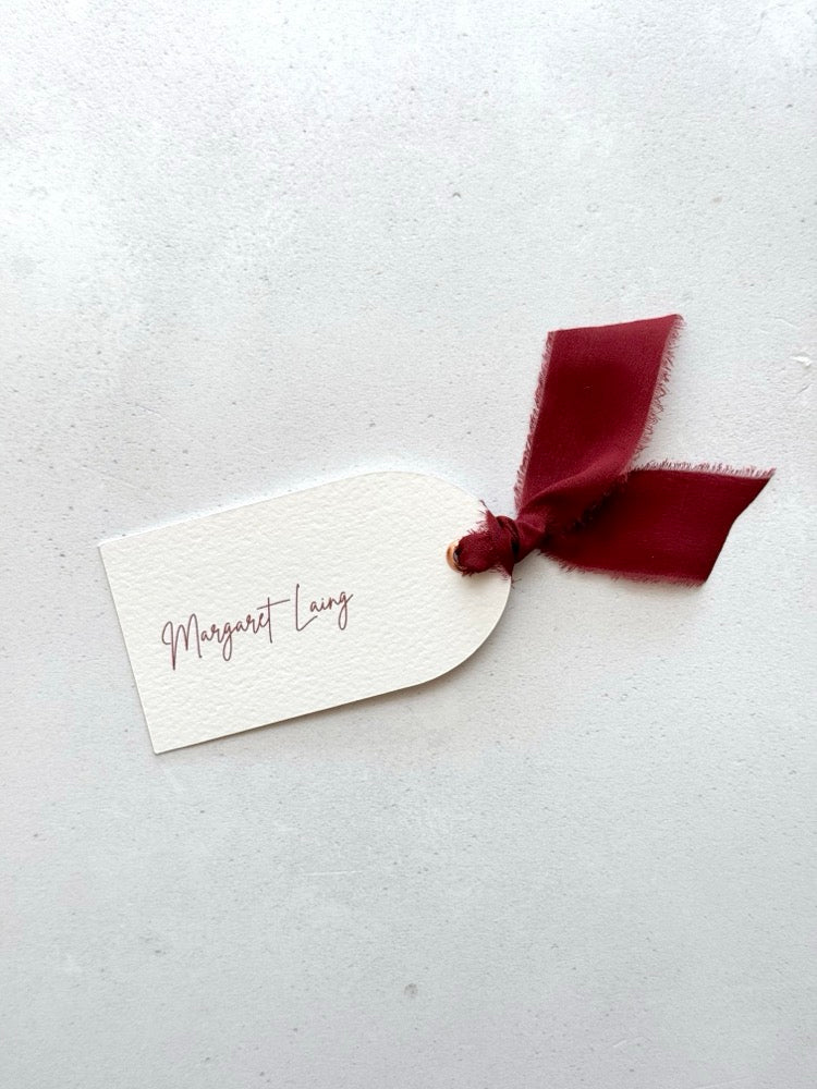 Emma arch place card with burgundy silk ribbon and metal eyelet and personalised guest name, Handmade by Zara Dumfries