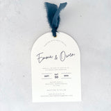 Handmade Emma arched wedding invite with navy silk ribbon and metal eyelet