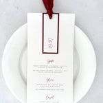 Emma wedding menu with tag, gold eyelet and burgundy silk ribbon