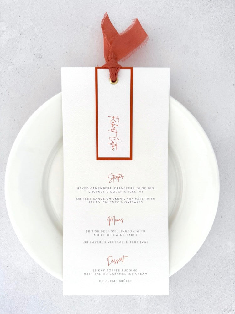 Terracotta orange personalised wedding menu with name tag and silk ribbon