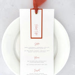 Terracotta orange personalised wedding menu with name tag and silk ribbon