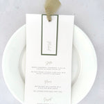 handmade Emma wedding menu with sage green silk ribbon, personalised name tag, and silver eyelet.