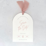 Textured white arched shaped save the date card with blush pink ribbon and  metal eyelet Handmade by Zara Dumfries