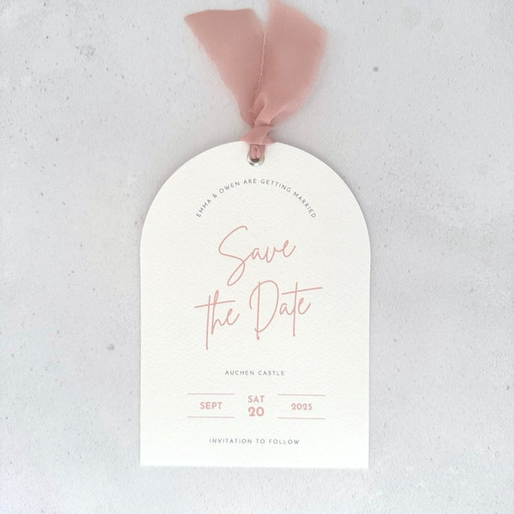 Textured white arched shaped save the date card with blush pink ribbon and  metal eyelet Handmade by Zara Dumfries