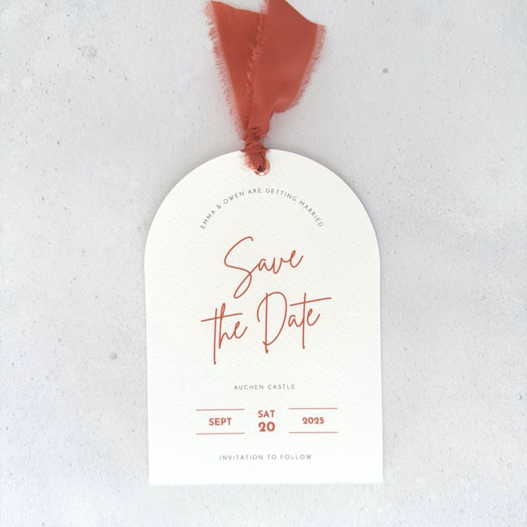 Textured white arched shaped save the date card with burnt orange ribbon and  metal eyelet Handmade by Zara Dumfries