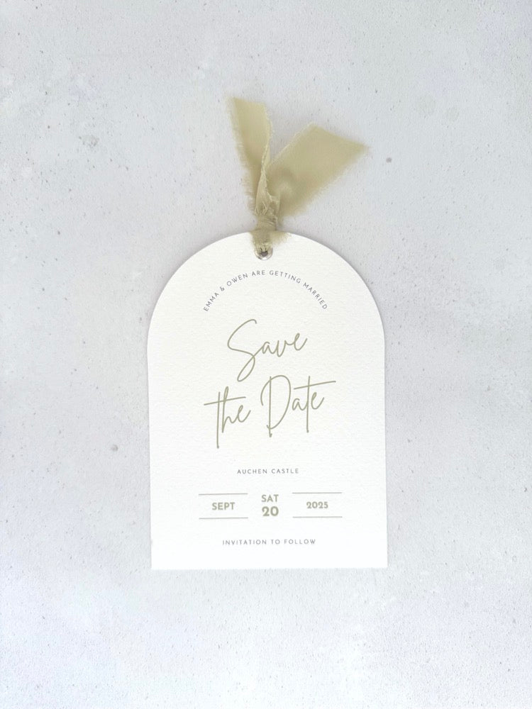 Textured white arched shaped save the date card with sage green ribbon and  metal eyelet Handmade by Zara Dumfries