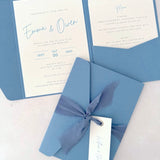 dusky cornflower blue emma pocketfold wedding invite with 2 inserts for menu and accommodation details, with silk ribbon and guest name tag