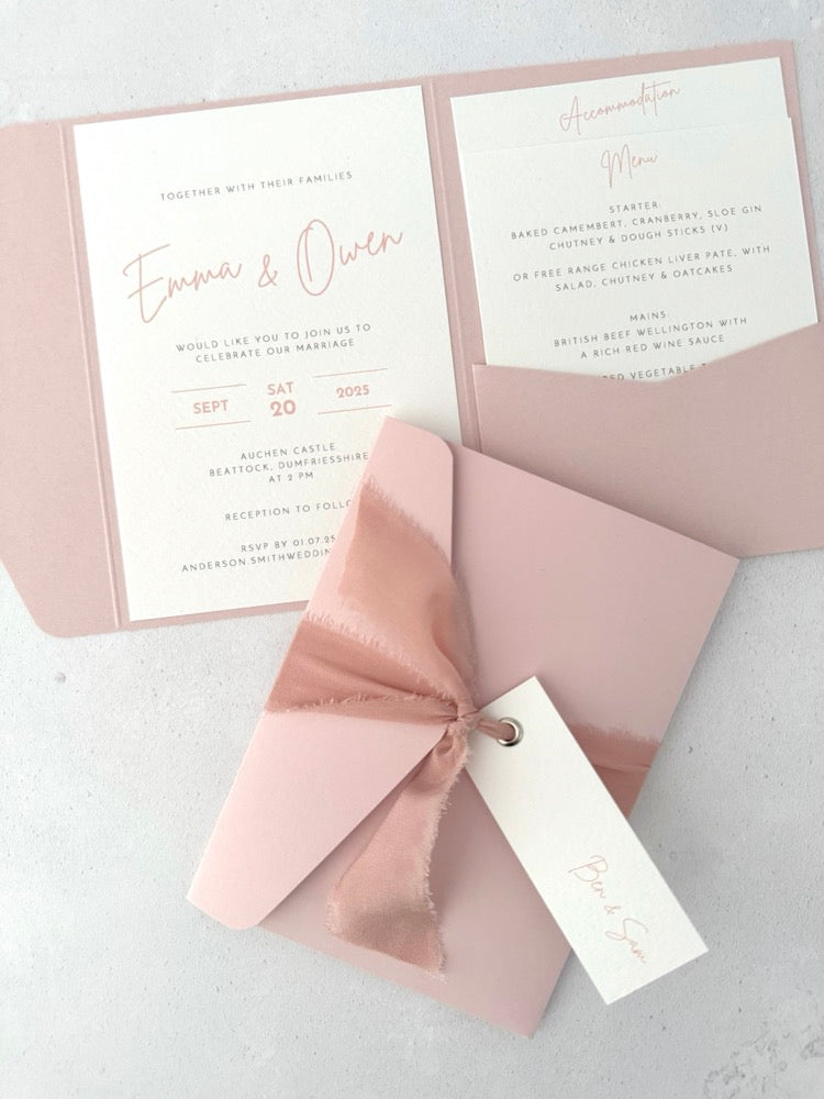 blush pink emma pocketfold wedding invite with 2 inserts for menu and accommodation details, with silk ribbon and guest name tag