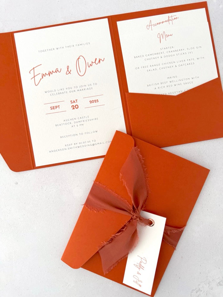 rust terracotta orange emma pocketfold wedding invite with 2 inserts for menu and accommodation details, with silk ribbon and guest name tag