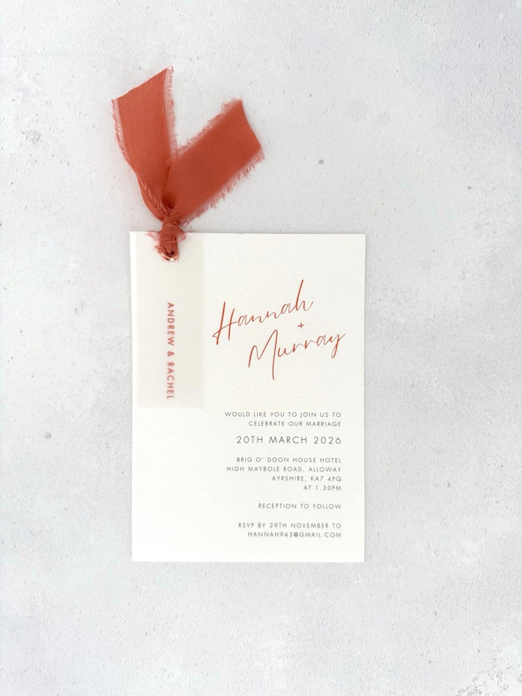 burnt orange wedding invite with vellum name tag, metal eyelet, and tied silk ribbon Handmade by Zara 