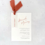 burnt orange wedding invite with vellum name tag, metal eyelet, and tied silk ribbon Handmade by Zara 