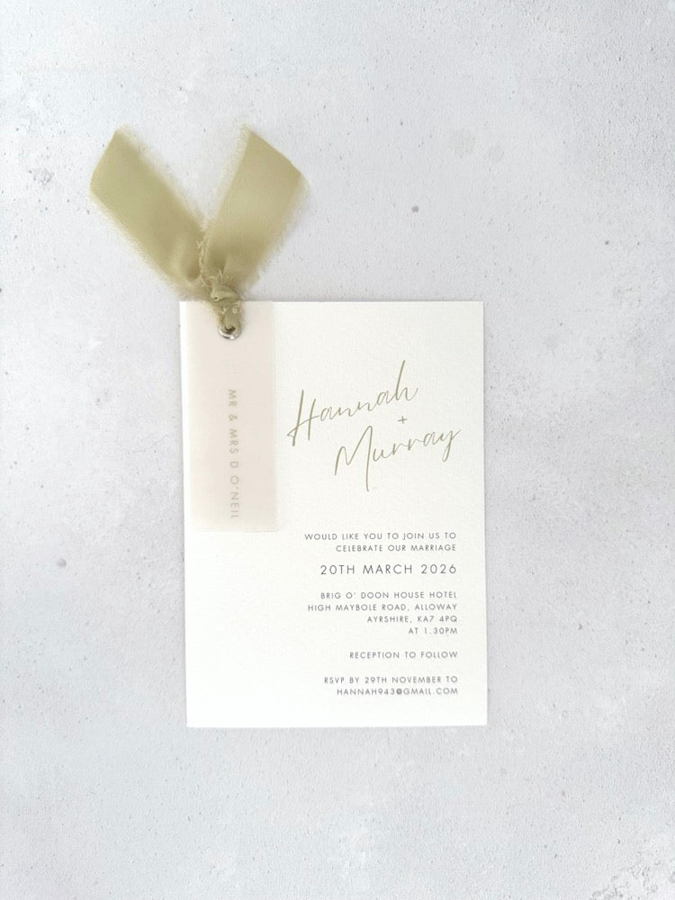 Sage green Hannah wedding invite with vellum name tag, metal eyelet, and tied silk ribbon Handmade by Zara 