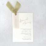 Sage green Hannah wedding invite with vellum name tag, metal eyelet, and tied silk ribbon Handmade by Zara 