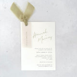 Sage green Hannah wedding invite with vellum name tag, metal eyelet, and tied silk ribbon Handmade by Zara 