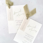 Sage green silk ribbon Hannah handmade wedding invite with printed guest names on vellum tags