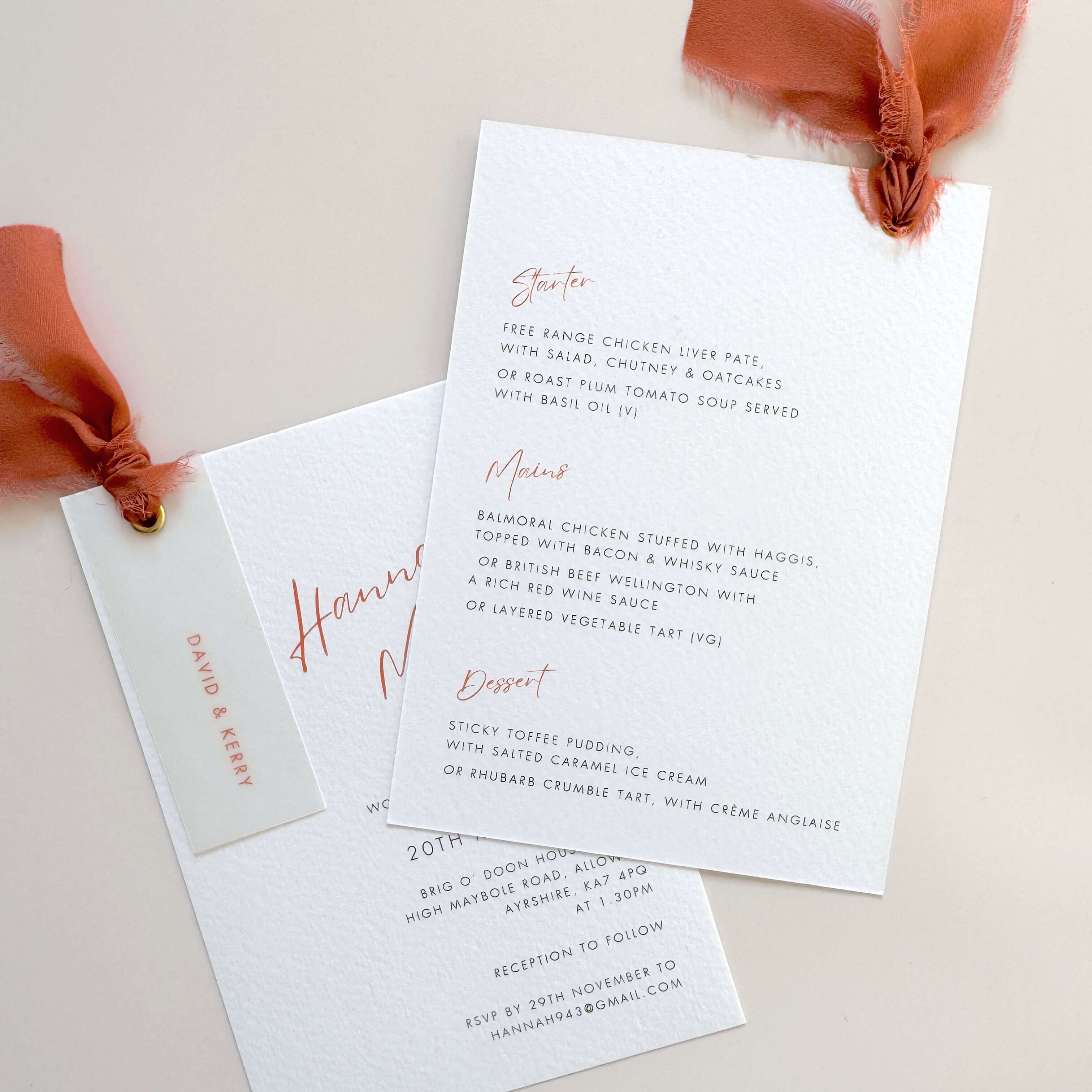 Terracotta burnt orange wedding invite with vellum name tag, metal eyelet, and tied silk ribbon Handmade by Zara 