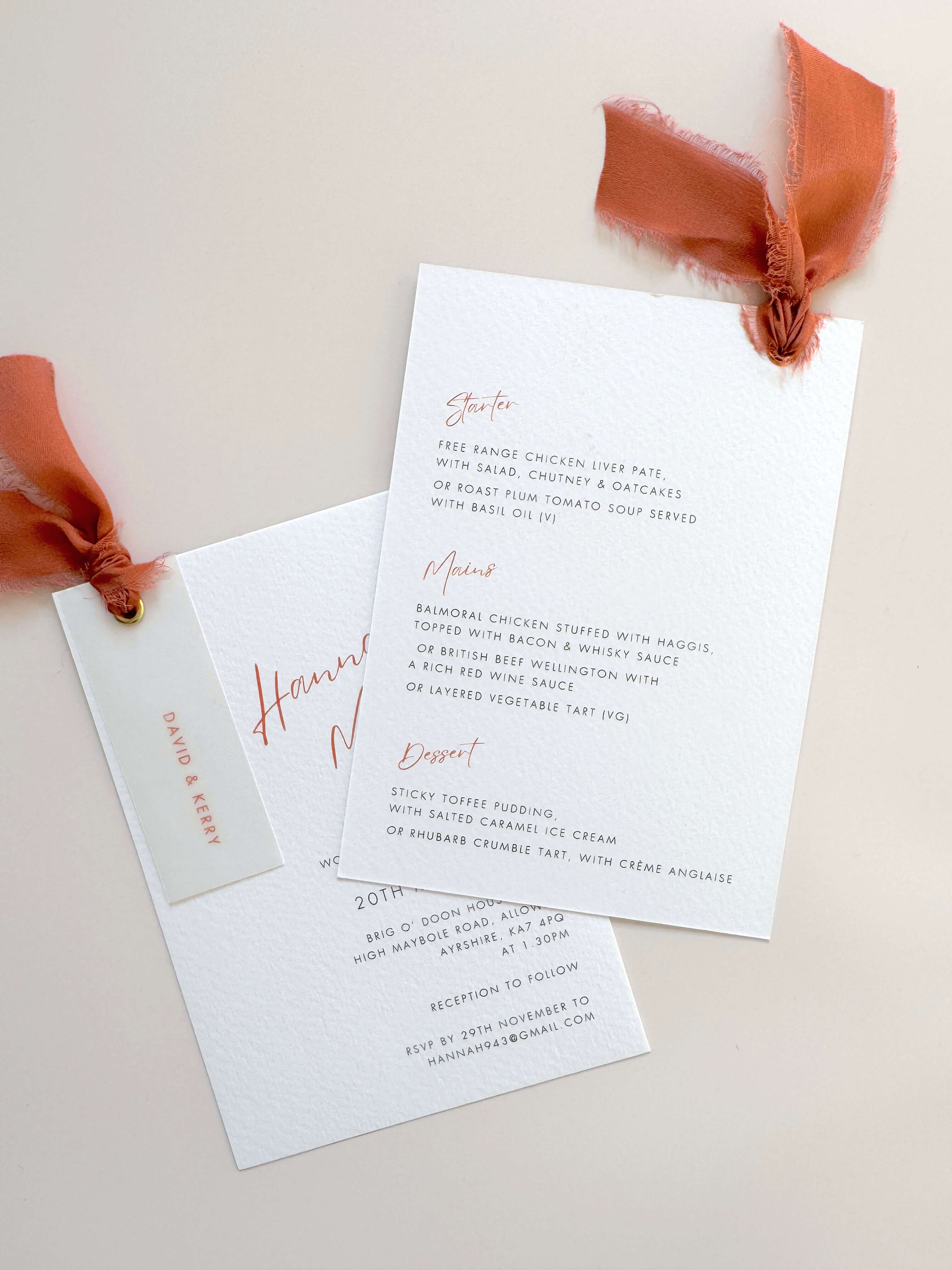 Terracotta burnt orange wedding invite with vellum name tag, metal eyelet, and tied silk ribbon Handmade by Zara 