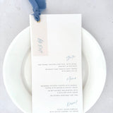 Handmade wedding day menu with dusky cornflower blue silk ribbon, vellum tag, and golf metal eyelet