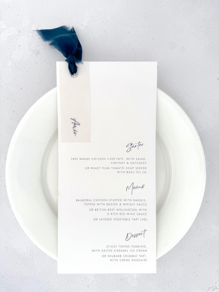 Handmade wedding menu with navy blue silk ribbon with personalised guest name on vellum