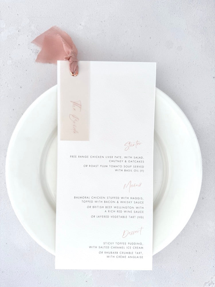 Blush pink silk ribbon and eyelet wedding day menu with personalised vellum tag for The Bride