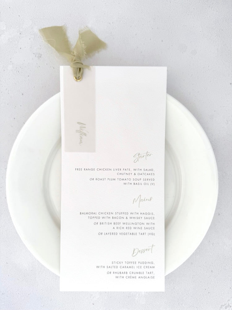 Wedding breakfast menu with sage green silk ribbon with personalised guest name printed on vellum with gold metal eyelet