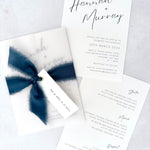 Navy Hannah vellum wrap wedding invite with tied silk ribbon and guest name tag. Insert card for wedding info and menu options. Brig O'Doon