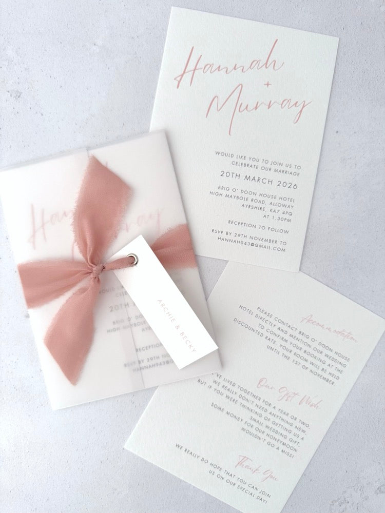 Pink Hannah vellum wrap wedding invite with tied silk ribbon and guest name tag. Insert card for wedding info and menu options. Handmade by Zara 