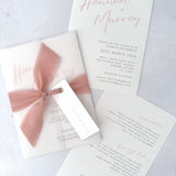 Pink Hannah vellum wrap wedding invite with tied silk ribbon and guest name tag. Insert card for wedding info and menu options. Handmade by Zara 