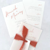 Hannah wedding invitation with tied silk ribbon and transparent vellum jacket. Guest name tag with metal eyelet.  Insert card for wedding info and menu options. 