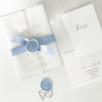 dusty blue wax seal and ribbon invite vellum jacket 