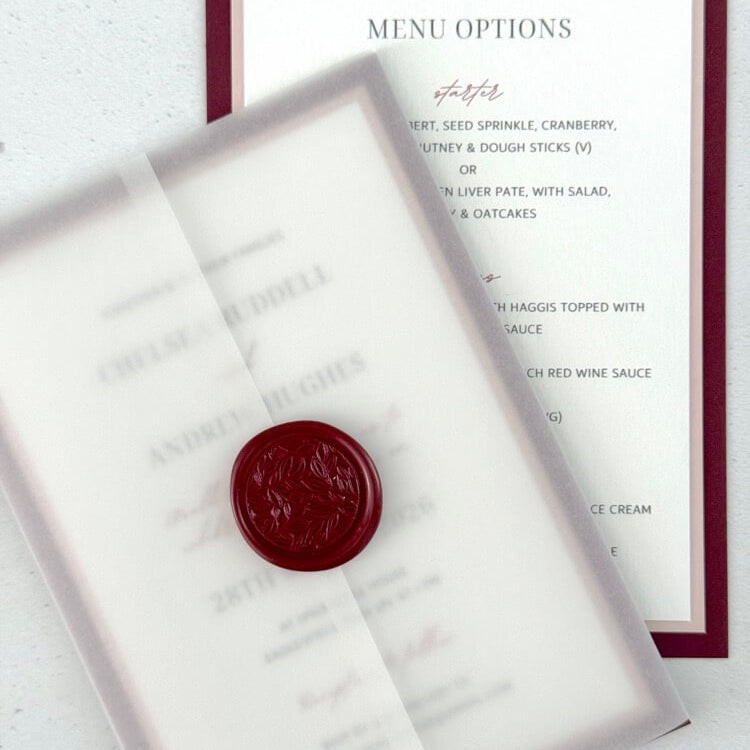 Burgundy wedding invite with transparent vellum paper wrap and wax seal